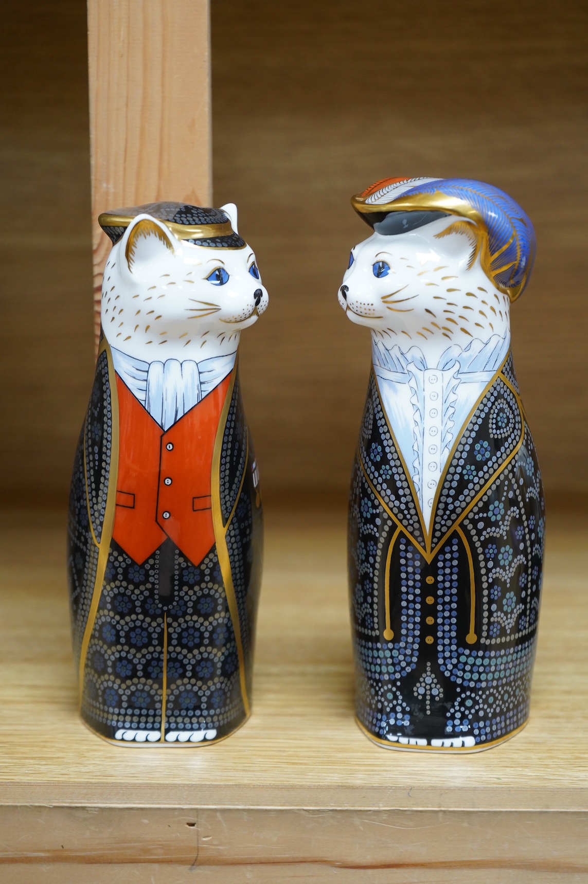 Two Royal Crown Derby cats compromising Pearly Queen and King, one with stopper, largest 20cm high